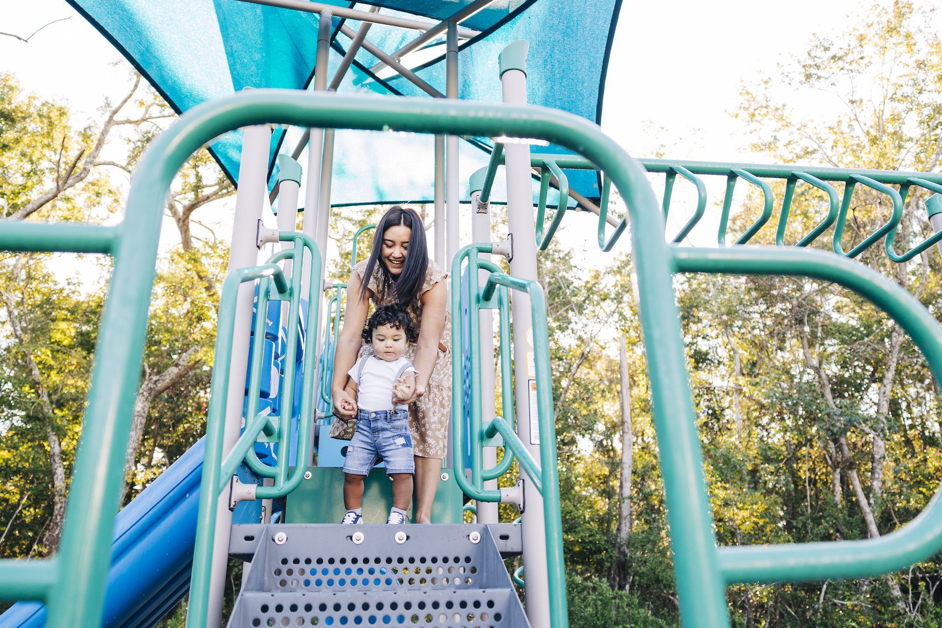 Evolve Deep river family playing on a playground